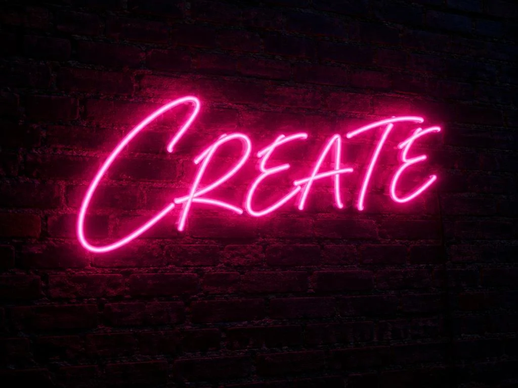 Glowing neon sign mounted on dark brick.